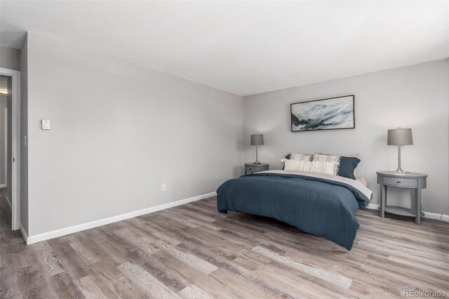 bedroom with hardwood / wood-style flooring