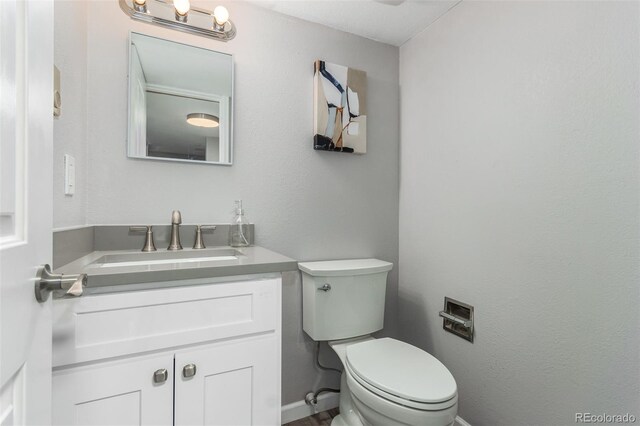 bathroom with toilet and vanity