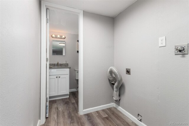 laundry area featuring hookup for an electric dryer, hardwood / wood-style floors, washer hookup, sink, and hookup for a gas dryer