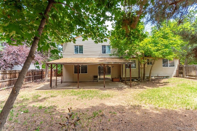 rear view of property featuring a patio area and a lawn