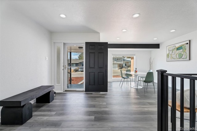 entryway with dark hardwood / wood-style flooring and a textured ceiling