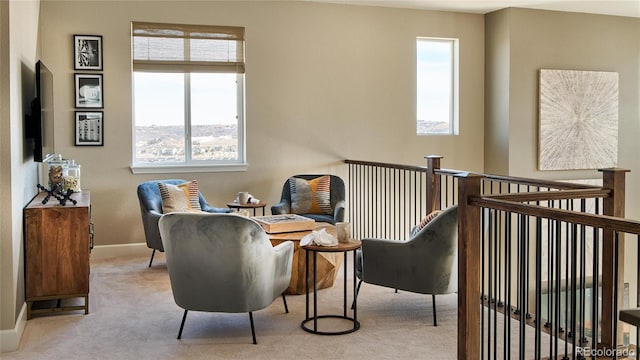 sitting room featuring light colored carpet