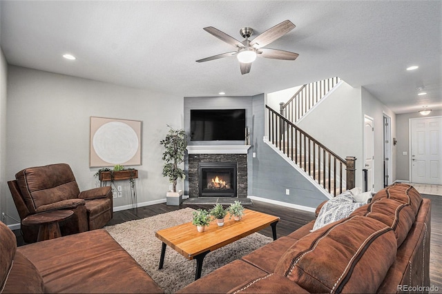 1473 Castle Creek Cir, Castle Rock, CO 80104 - living room featuring wood finished floors, ceiling fan, a stone fireplace, stairway, and recessed lighting