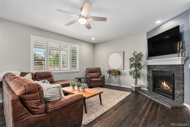 1473 Castle Creek Cir, Castle Rock, CO 80104 - living area with dark wood-style flooring, a ceiling fan, a stone fireplace, and recessed lighting