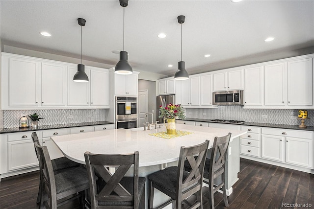 1473 Castle Creek Cir, Castle Rock, CO 80104 - kitchen with stainless steel appliances, decorative backsplash, recessed lighting, dark wood-type flooring, and pendant lighting
