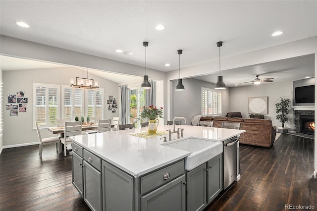 1473 Castle Creek Cir, Castle Rock, CO 80104 - kitchen featuring stainless steel dishwasher, gray cabinetry, dark wood-type flooring, ceiling fan, and light countertops