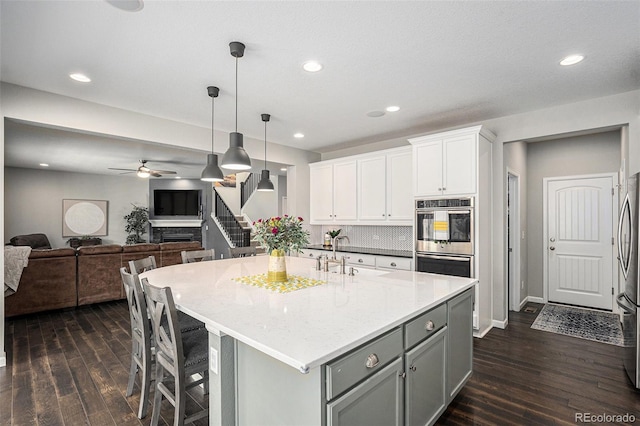 1473 Castle Creek Cir, Castle Rock, CO 80104 - kitchen with appliances with stainless steel finishes, dark wood-type flooring, gray cabinetry, ceiling fan, and recessed lighting