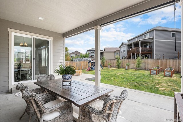 1473 Castle Creek Cir, Castle Rock, CO 80104 - fenced backyard with a patio area, a playground, outdoor dining area, and a residential view