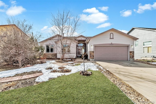 view of front of house featuring a garage, stone siding, a front lawn, and concrete driveway