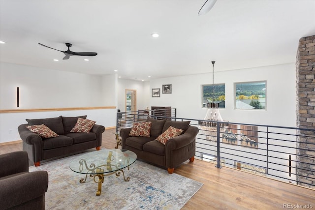 living room with light hardwood / wood-style floors and ceiling fan