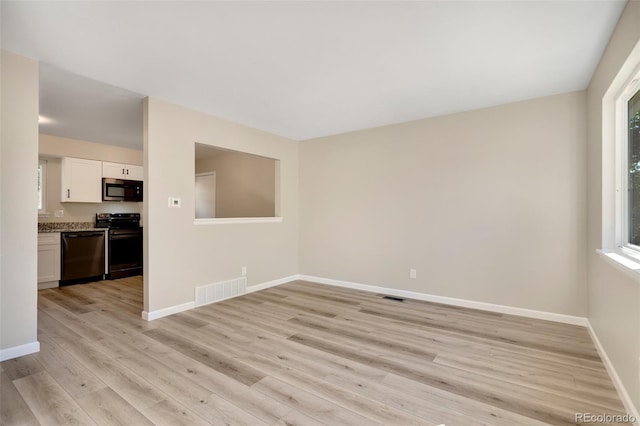 spare room with light hardwood / wood-style flooring