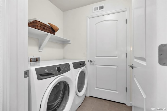 4569 Copeland Loop Unit 203, Highlands Ranch, CO 80126 - laundry area with washing machine and dryer and light tile patterned flooring