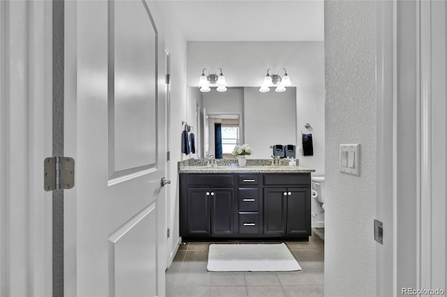 4569 Copeland Loop Unit 203, Highlands Ranch, CO 80126 - bathroom with tile patterned floors, double vanity, and a textured wall