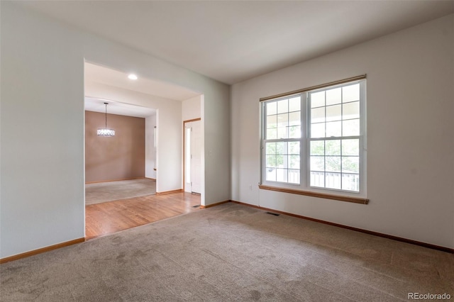 5571 S Sicily St, Aurora, CO 80015 - carpeted empty room featuring baseboards and a chandelier