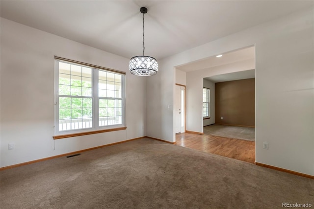 5571 S Sicily St, Aurora, CO 80015 - spare room featuring carpet flooring and a chandelier