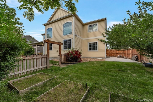 5571 S Sicily St, Aurora, CO 80015 - rear view of property featuring a garden and a patio area