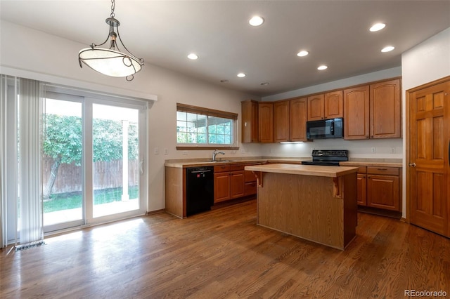 5571 S Sicily St, Aurora, CO 80015 - kitchen with black appliances, light countertops, a center island, dark wood finished floors, and recessed lighting