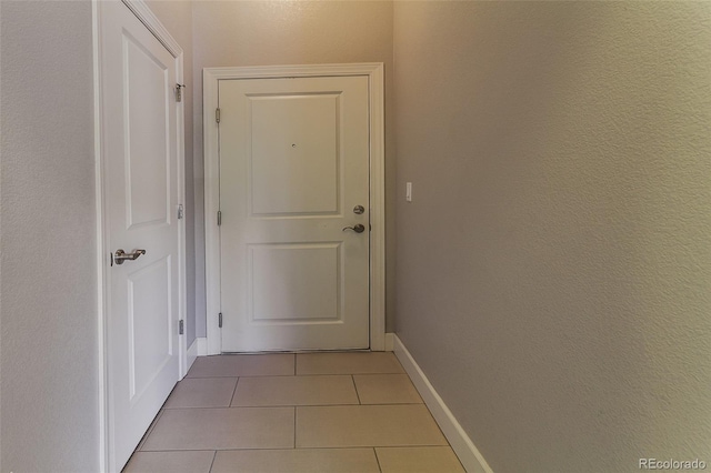 hall with light tile patterned flooring