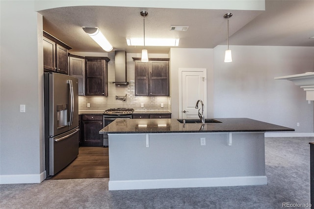 kitchen with a kitchen island with sink, dark colored carpet, sink, wall chimney exhaust hood, and stainless steel appliances