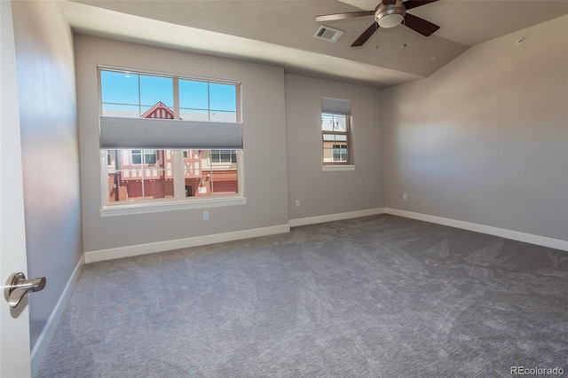 spare room featuring ceiling fan, carpet, and vaulted ceiling