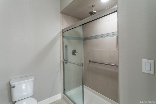 bathroom featuring toilet and walk in shower