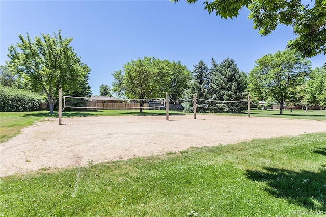 surrounding community with volleyball court and a lawn