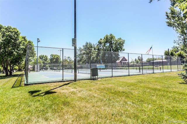 view of sport court featuring a lawn