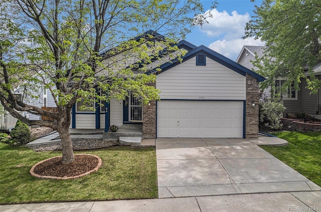 view of front of house featuring brick siding, a garage, concrete driveway, and a front yard