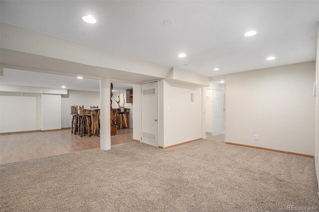 finished basement featuring carpet floors, baseboards, and recessed lighting
