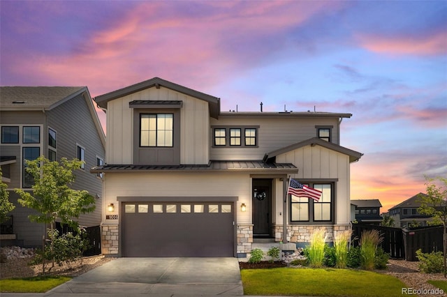 9016 Moondance Dr, Littleton, CO 80125 - view of front of home with a standing seam roof, stone siding, and a garage