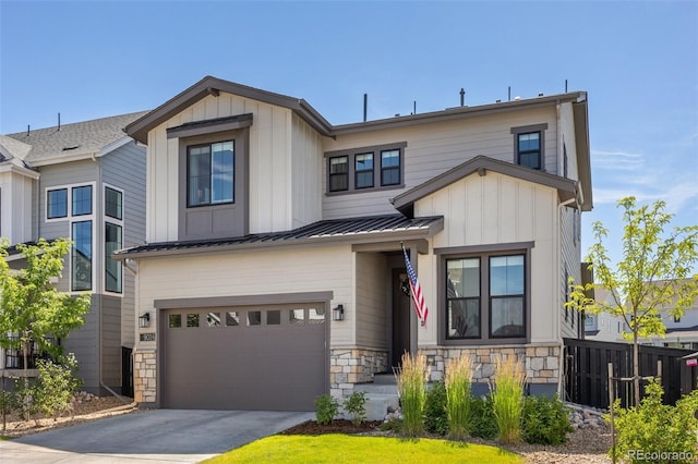 9016 Moondance Dr, Littleton, CO 80125 - view of front of home featuring an attached garage, concrete driveway, stone siding, a metal roof, and board and batten siding