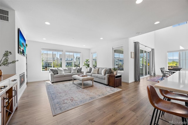 9016 Moondance Dr, Littleton, CO 80125 - living area featuring healthy amount of natural light, wood finished floors, and recessed lighting