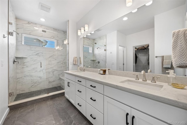 9016 Moondance Dr, Littleton, CO 80125 - full bathroom with marble finish flooring, a marble finish shower, double vanity, a spacious closet, and recessed lighting