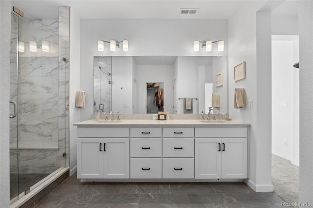 9016 Moondance Dr, Littleton, CO 80125 - bathroom featuring marble finish floors, a marble finish shower, double vanity, and a walk in closet