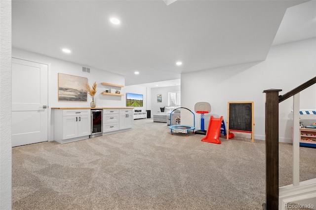 9016 Moondance Dr, Littleton, CO 80125 - playroom featuring wine cooler, light colored carpet, and recessed lighting