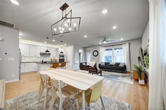 5771 Slate River Pl, Brighton, CO 80601 - dining area with light wood finished floors, recessed lighting, a ceiling fan, baseboards, and a chandelier