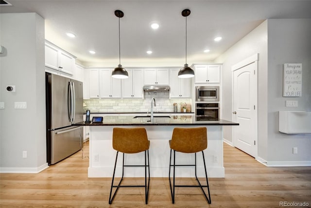5771 Slate River Pl, Brighton, CO 80601 - kitchen featuring appliances with stainless steel finishes, baseboards, white cabinetry, and recessed lighting