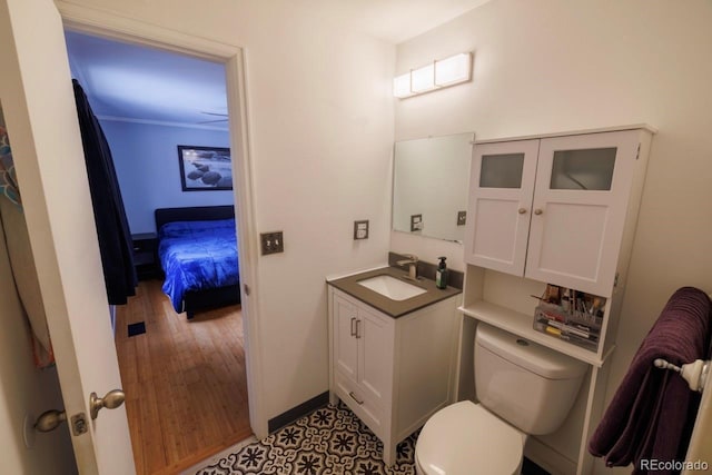 18908 E Napa Dr, Aurora, CO 80013 - bathroom featuring vanity, toilet, wood finished floors, and baseboards