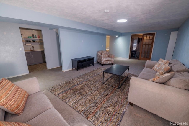 18908 E Napa Dr, Aurora, CO 80013 - carpeted living area with baseboards, a sink, and a textured ceiling