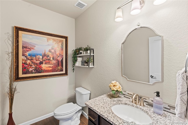 10091 Hannaway Dr, Colorado Springs, CO 80924 - half bath with wood finished floors, toilet, vanity, and baseboards