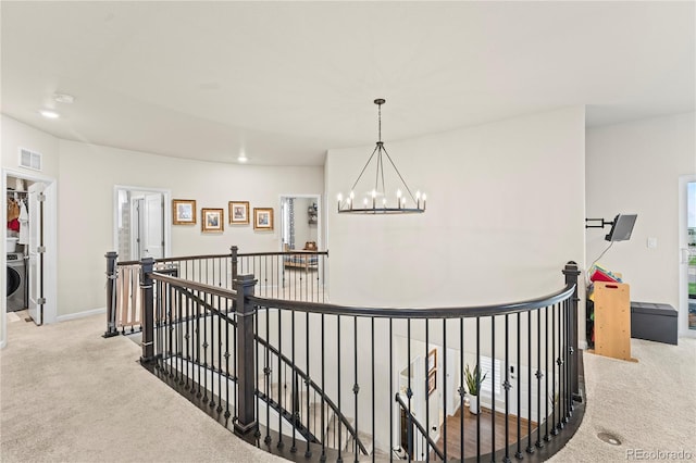 10091 Hannaway Dr, Colorado Springs, CO 80924 - corridor featuring an upstairs landing, carpet floors, a chandelier, washer / dryer, and baseboards