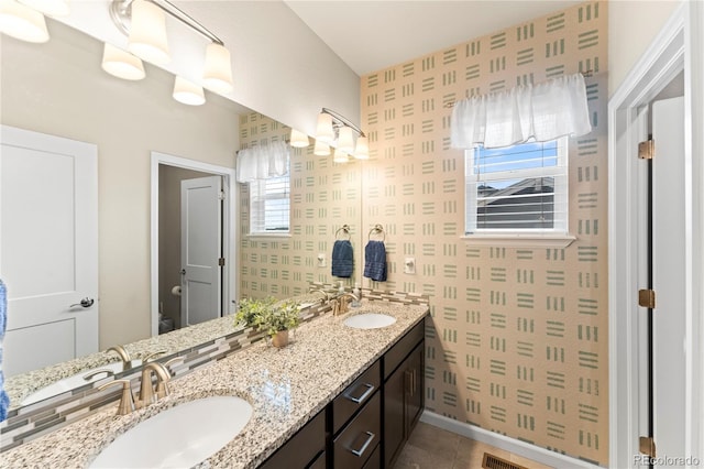 10091 Hannaway Dr, Colorado Springs, CO 80924 - bathroom featuring wallpapered walls, baseboards, toilet, double vanity, and tile patterned floors