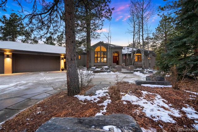 view of front of property with concrete driveway and an attached garage