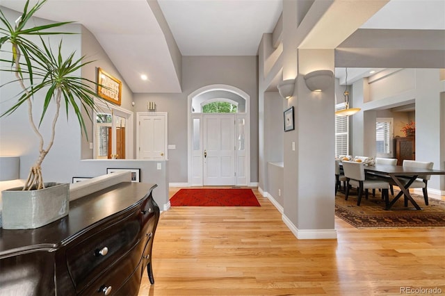 foyer featuring baseboards and light wood-style floors