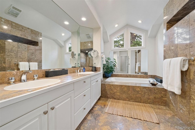 full bathroom featuring a sink, visible vents, lofted ceiling, and plenty of natural light