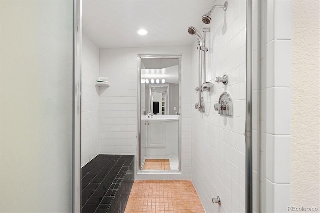 bathroom featuring vanity and a shower stall