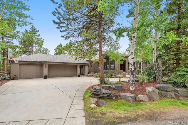 view of front of house with an attached garage, driveway, and stucco siding