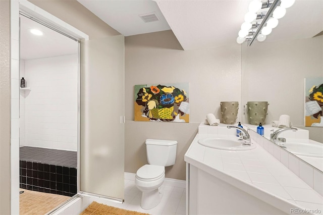 bathroom with a sink, visible vents, toilet, and tile patterned floors