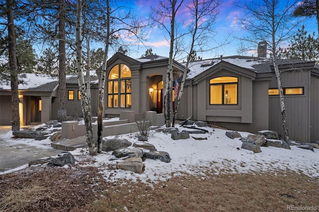 view of front of property with an attached garage and stucco siding