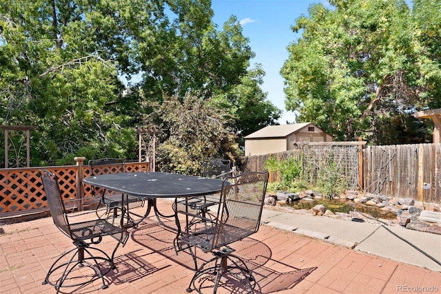 wooden deck with outdoor dining space, a patio area, and fence